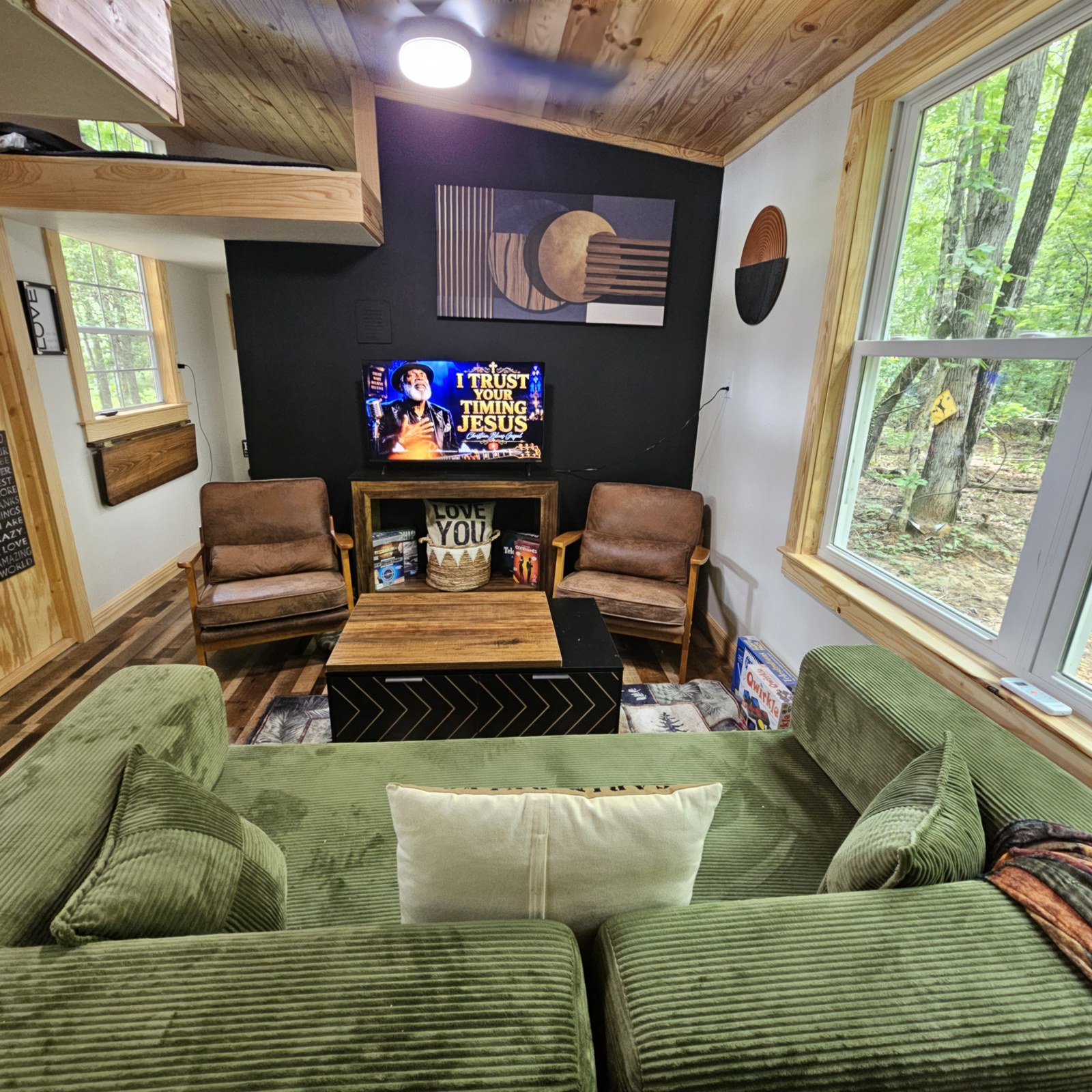 Full living room with seating, TV, and loft above