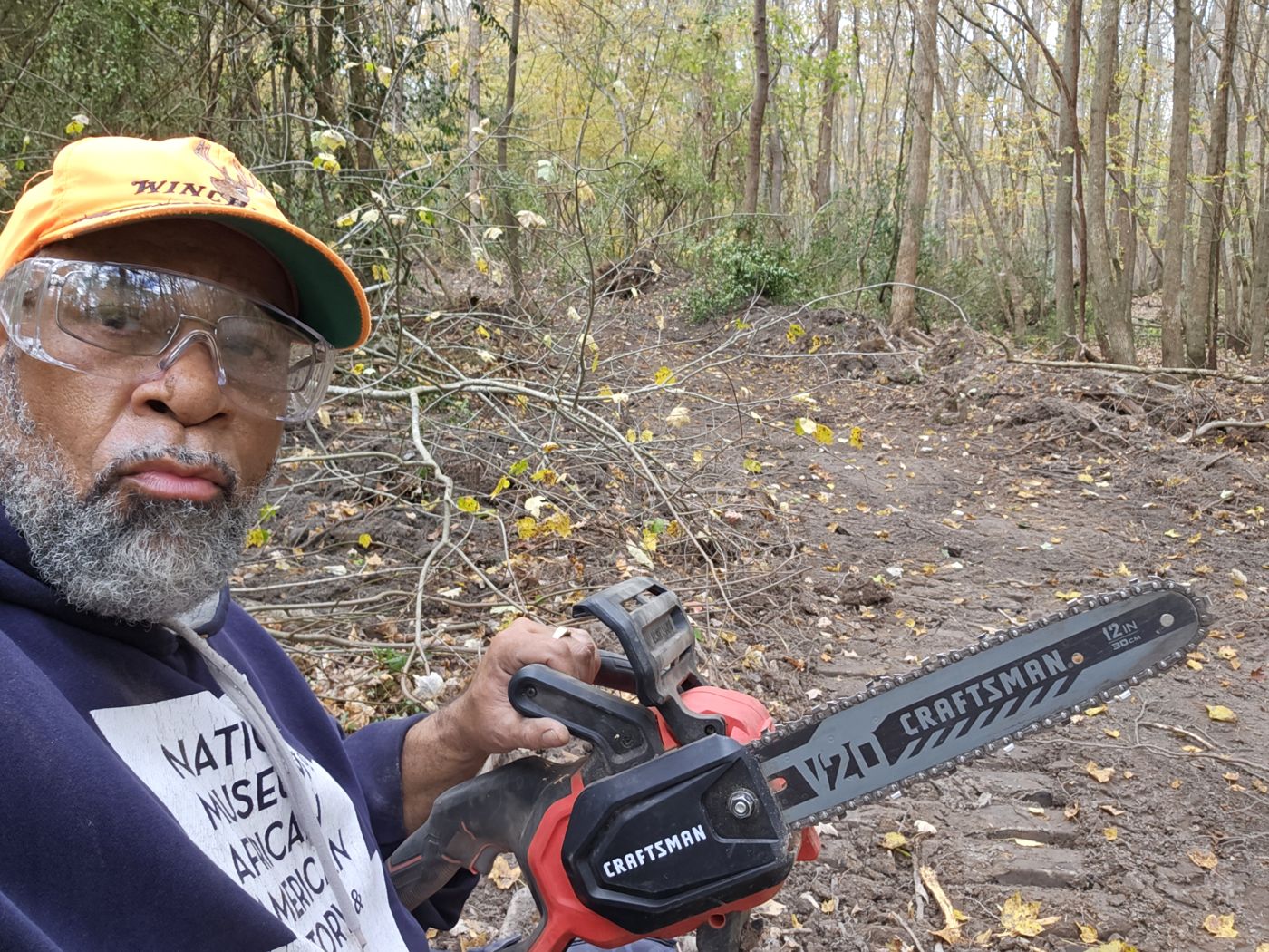 Clearing brush by hand to open a new trail